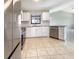 Contemporary kitchen featuring white cabinetry, tiled backsplash, and stainless steel appliances at 9308 San Bernandino Ave, Englewood, FL 34224