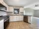Updated kitchen features stainless appliances, white cabinets, and granite countertops at 9308 San Bernandino Ave, Englewood, FL 34224