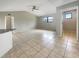 Bright living room featuring tile floors, neutral walls, and a modern ceiling fan at 9308 San Bernandino Ave, Englewood, FL 34224
