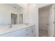Double vanity bathroom with white cabinets and quartz countertops at 17339 Peregrine Way, Punta Gorda, FL 33982