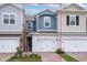 Charming two-story townhome with a brick driveway, attached garage, and professionally landscaped front yard at 17339 Peregrine Way, Punta Gorda, FL 33982