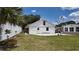 The back of a single story house with a detached garage and a fenced yard at 1620 Lakeview Pl, Englewood, FL 34223