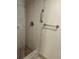 Updated bathroom with shower, grab bars, and tiled walls at 1620 Lakeview Pl, Englewood, FL 34223