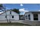 Rear view of a house with a detached garage and a large backyard at 1620 Lakeview Pl, Englewood, FL 34223