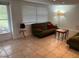 Living room with tiled floor, couch, and end tables at 1620 Lakeview Pl, Englewood, FL 34223