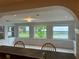 Sunroom features large windows offering backyard views at 1620 Lakeview Pl, Englewood, FL 34223