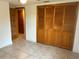 Bedroom with tiled floor, large closet, and access to another room at 1620 Lakeview Pl, Englewood, FL 34223