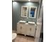 Bathroom boasts double sinks, marble vanity, and an updated look at 1620 Lakeview Pl, Englewood, FL 34223