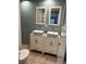 Bathroom boasts double sinks, marble vanity, and an updated look at 1620 Lakeview Pl, Englewood, FL 34223