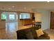 Living room features a couch and tiled floors with access to the kitchen at 1620 Lakeview Pl, Englewood, FL 34223