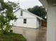 White house exterior with a detached garage and a small patio area at 1620 Lakeview Pl, Englewood, FL 34223