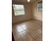 Bright bedroom featuring tiled flooring and a window with blinds at 1620 Lakeview Pl, Englewood, FL 34223