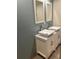 Bathroom with double vanity, marble countertop, and updated fixtures at 1620 Lakeview Pl, Englewood, FL 34223
