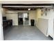 Garage with a workbench, storage, and a door to backyard at 1620 Lakeview Pl, Englewood, FL 34223