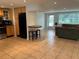 Open concept kitchen and living area with tile floors at 1620 Lakeview Pl, Englewood, FL 34223