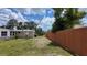 Side view of a ranch style house with a wooden privacy fence at 1620 Lakeview Pl, Englewood, FL 34223