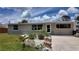 A beige ranch style home with a landscaped front yard and walkway at 1620 Lakeview Pl, Englewood, FL 34223