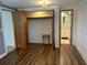 Bedroom with wood-look flooring, a closet, and bathroom access at 1620 Lakeview Pl, Englewood, FL 34223