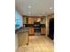 Bright kitchen with wood cabinets and stainless steel appliances at 1620 Lakeview Pl, Englewood, FL 34223