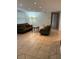 Spacious living room with tiled floors and two green couches at 1620 Lakeview Pl, Englewood, FL 34223