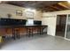 Garage workshop with long workbench and barstools at 1620 Lakeview Pl, Englewood, FL 34223