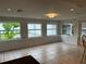 Sunroom with tile flooring and large windows overlooking backyard at 1620 Lakeview Pl, Englewood, FL 34223