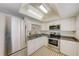 Modern white kitchen with stainless steel appliances at 1433 S Belcher Rd # C1, Clearwater, FL 33764