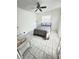 Cozy bedroom with a queen-sized bed, tiled floors, and a ceiling fan at 1433 S Belcher Rd # C1, Clearwater, FL 33764