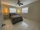 Spacious bedroom with a queen bed, ceiling fan, and tiled floors at 1433 S Belcher Rd # C1, Clearwater, FL 33764