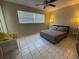 Comfortable bedroom with a queen bed, ceiling fan, and tiled floors at 1433 S Belcher Rd # C1, Clearwater, FL 33764