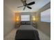 Bright bedroom with a queen bed, tiled floors, and two floor lamps at 1433 S Belcher Rd # C1, Clearwater, FL 33764