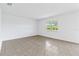 Spacious bedroom with tile flooring and large window at 9034 Sandy Bluffs Cir, Parrish, FL 34219