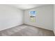 Simple bedroom with grey carpet and a window at 9034 Sandy Bluffs Cir, Parrish, FL 34219