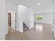 Foyer with staircase, tile floors, and a view of a bathroom at 9034 Sandy Bluffs Cir, Parrish, FL 34219