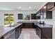Kitchen with dark cabinets, granite countertops, and stainless steel appliances at 9034 Sandy Bluffs Cir, Parrish, FL 34219