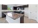 Kitchen with dark cabinets, granite countertops, and an island at 9034 Sandy Bluffs Cir, Parrish, FL 34219