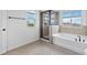 Bathroom with a shower, bathtub, and large windows at 9034 Sandy Bluffs Cir, Parrish, FL 34219