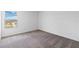 Bright bedroom with carpet flooring and a window offering a view at 9034 Sandy Bluffs Cir, Parrish, FL 34219