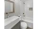 Clean bathroom with white tub and gray vanity at 4104 W Gray St, Tampa, FL 33609