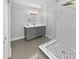 Modern bathroom with gray vanity, marble shower, and white fixtures at 4104 W Gray St, Tampa, FL 33609