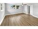 Simple bedroom with wood-look floors and two windows at 4104 W Gray St, Tampa, FL 33609