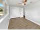 Bright bedroom featuring wood-look floors and ceiling fan at 4104 W Gray St, Tampa, FL 33609