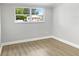 Simple bedroom with wood flooring and a window at 4104 W Gray St, Tampa, FL 33609