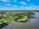 Aerial view of property located on the water, surrounded by other houses at 9573 Shelburne Cir, Port Charlotte, FL 33981