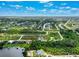 Aerial view showing a house on a large lot, near water and other homes at 9573 Shelburne Cir, Port Charlotte, FL 33981