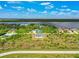 Aerial view of single-story home with water views at 9573 Shelburne Cir, Port Charlotte, FL 33981