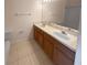 Double vanity bathroom with light beige tile floors at 8882 Christie Dr, Largo, FL 33771