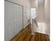 Hallway with hardwood floors, white doors, and staircase at 8882 Christie Dr, Largo, FL 33771