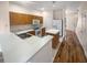 Kitchen with wood cabinets, island, and hardwood floors at 8882 Christie Dr, Largo, FL 33771