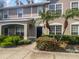 Two-story townhome with a dark door and landscaping at 8882 Christie Dr, Largo, FL 33771
